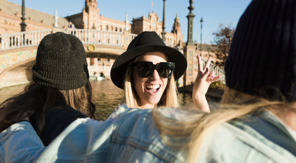 Smiling people in a boat, square in the background.