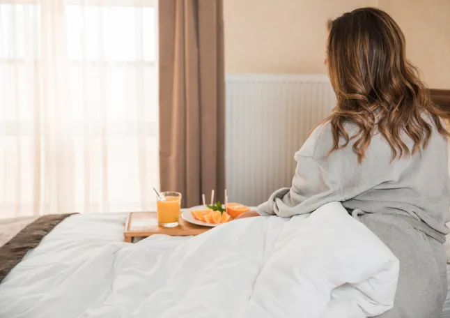 Woman having breakfast in bed.