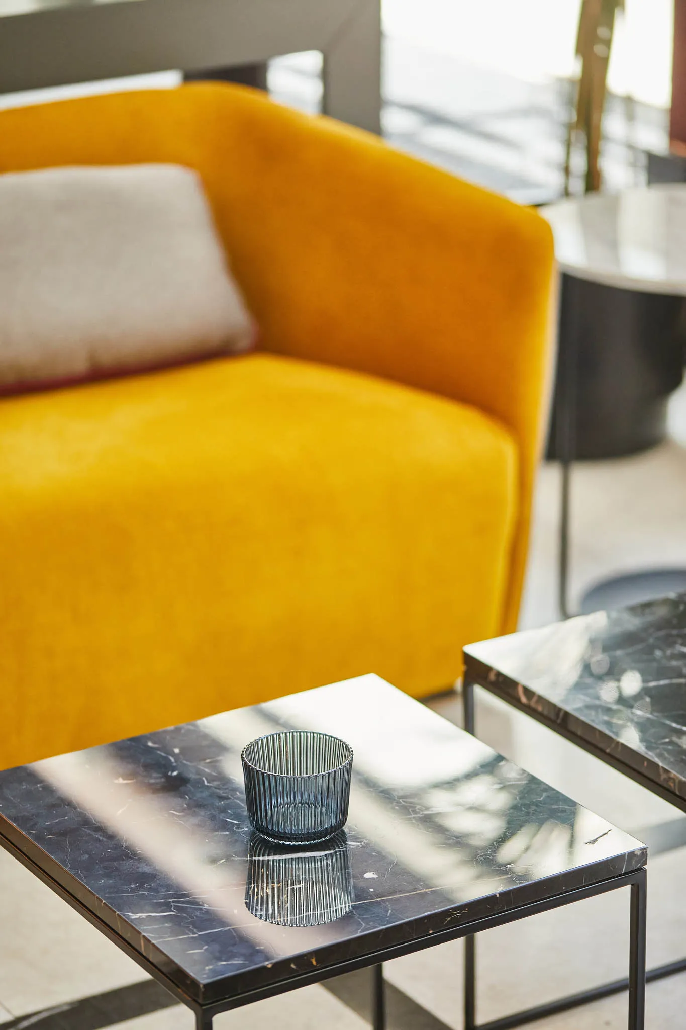 Canapé jaune et table en marbre.