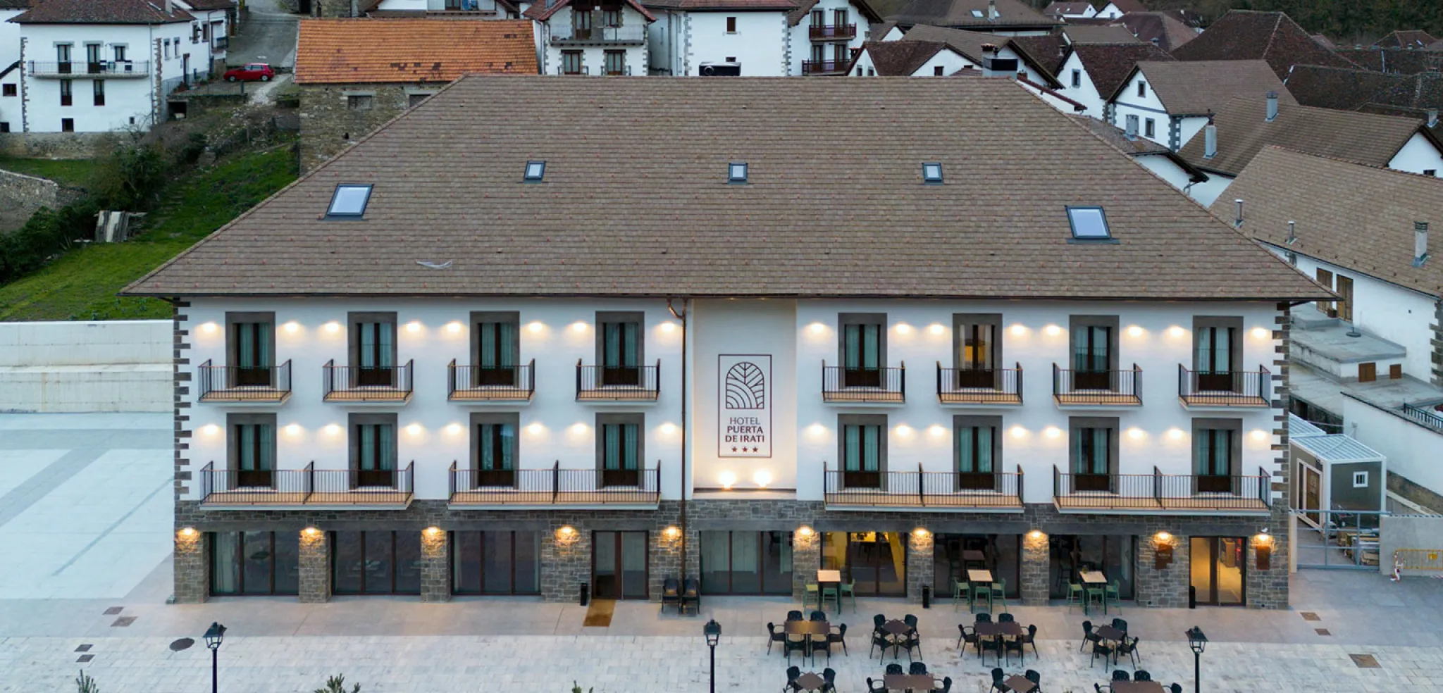 Hotel facade with illuminated balconies.