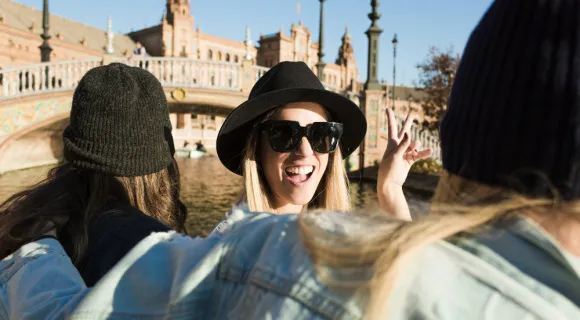 Smiling people in a boat, square in the background.